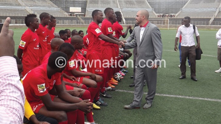 Kalaitzis (in grey suit) greeting Bullets players recently