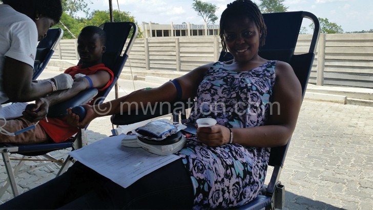 Sangwaning Nyasulu (right) FMB's Customer Service Officer donating blood during the drive