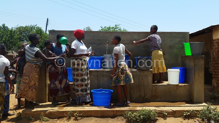 Women from Chatha village drawing water from a kiosk