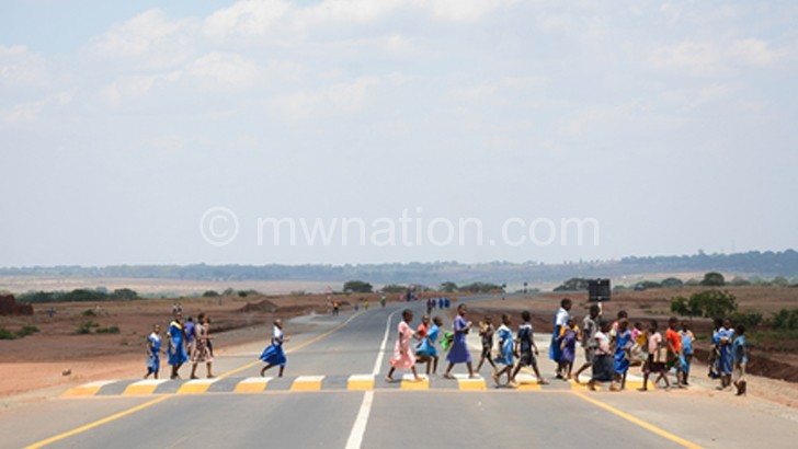 School children crossing the road at a zebra crossing