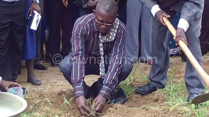 Chimwaza planting a tree during the launch