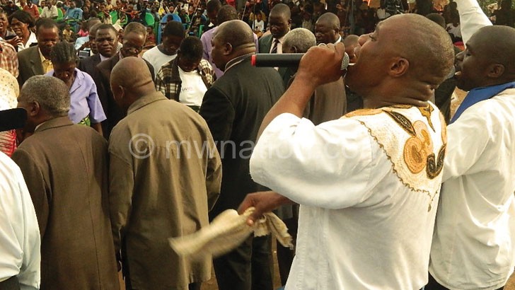 Apostle Lumwira (R) leads the clergy in praying for the country and its leadership 