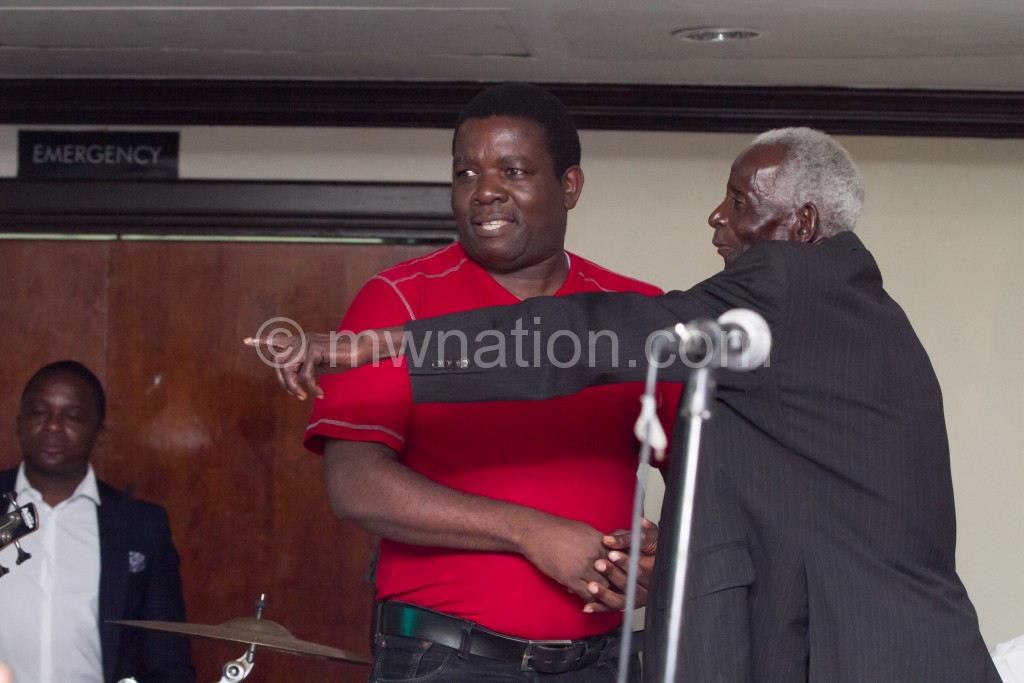 Chalamanda (R) gestures as Chilewe looks on during the Blantyre event