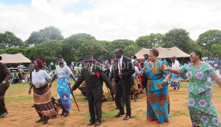 Kaliati (2nd R) joins the Honala dance with her principal secretary Mary Shaba (R) and others