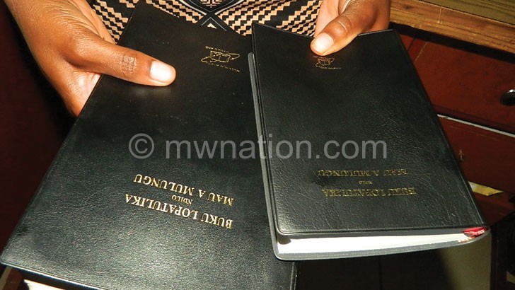 A Bible user holds the old (L) and the new versions 