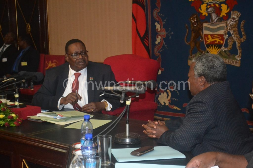 Mutharika and some PAC members in an earlier meeting