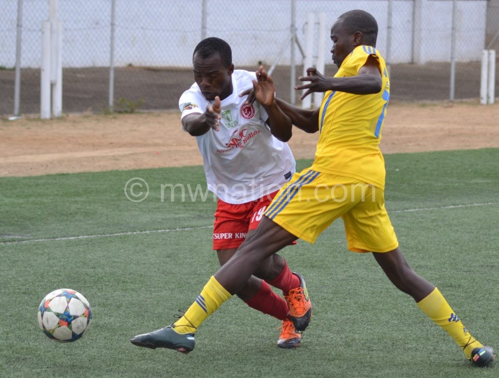 Bullets winger McFarlen Mgwira tries (L) to beat Sable’s Waddie Chikonde