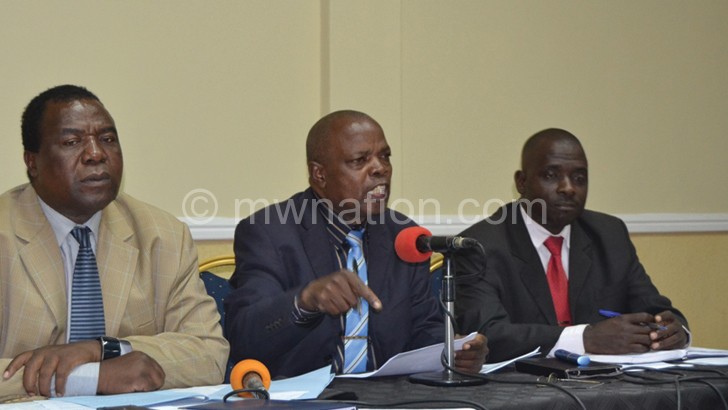 Muwake (C) stresses a point as Kalekeni (L) and another member look on