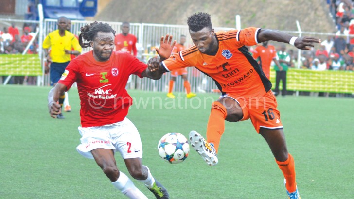 Impressive: Wanderers striker Bello (R) outpaces  Bullets’ Kondowe during the match