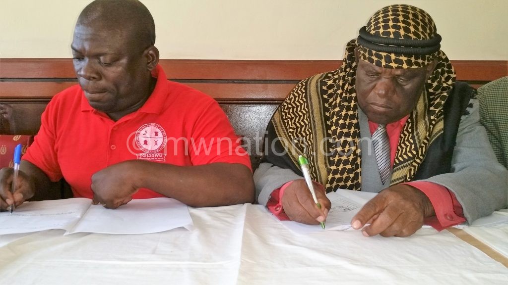 Nasimba (R) and Chiwaya sign the MoU
