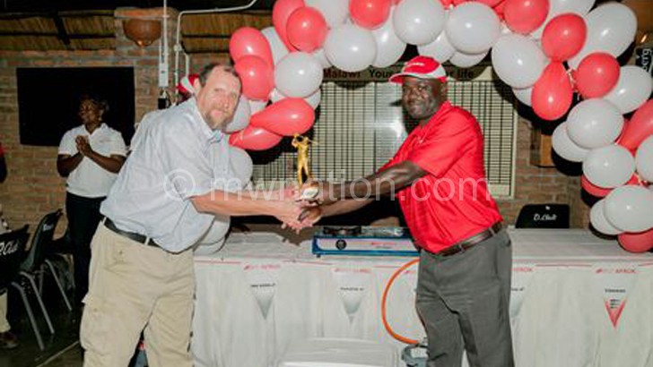 Douds (L) receives his trophy from Chima 