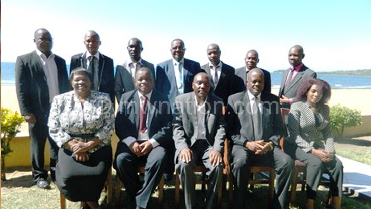 Sembereka (seated C) poses with Kachama (seated 2nd R), commissioners of police and other police officers 