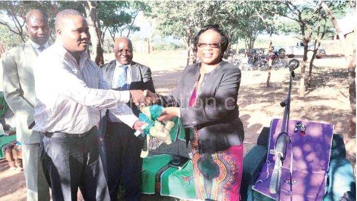 Tembo (R) hands over keys to Ngozo 