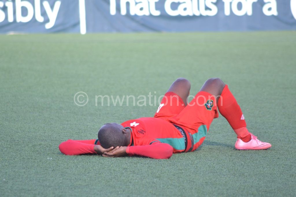 A disappointed Chiukepo lies on the turf after Flames’  loss to Guinea recently