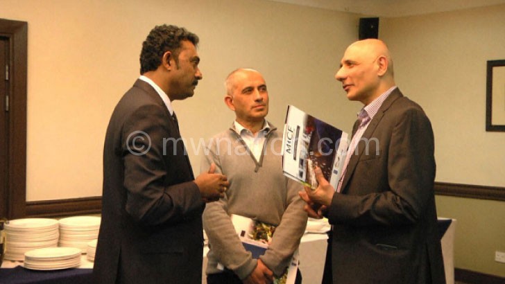 Micf fund manager Navin Kumar (L) interacts with some of the participants at the launch yesterday