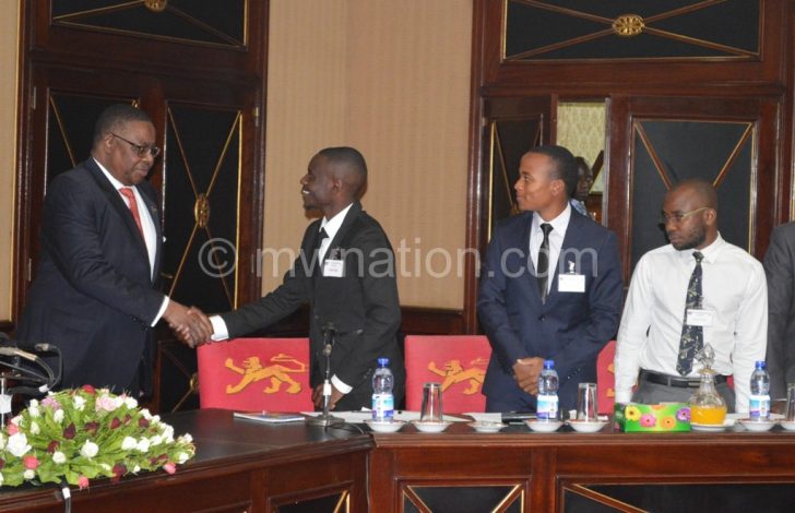 Mutharika greets the students’ at the start of the meeting
