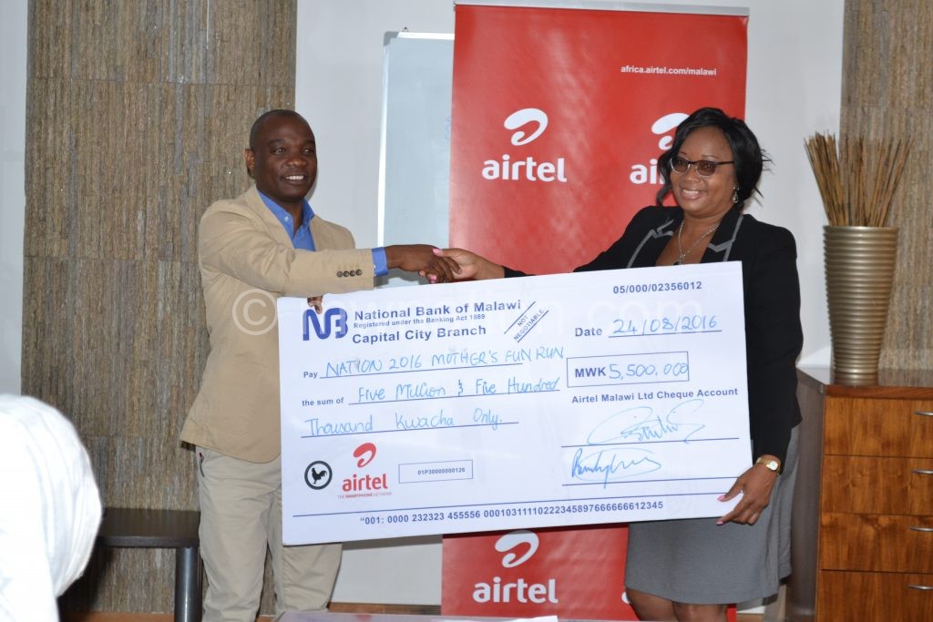 Kamoto hands over a symbolic cheque to Banda