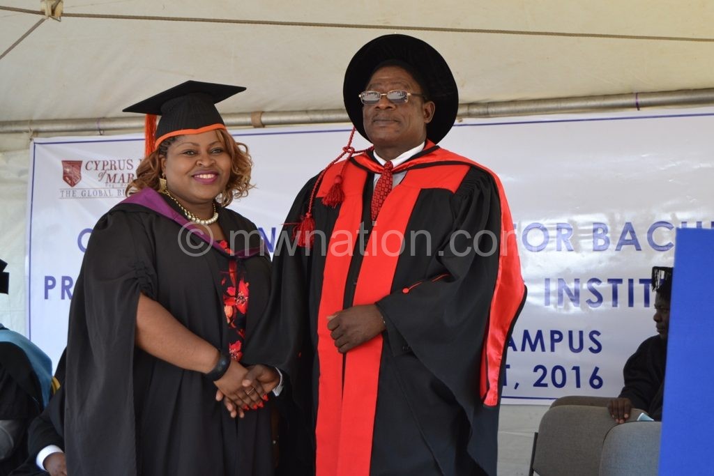 Luhanga (R) congratulates one of the graduands