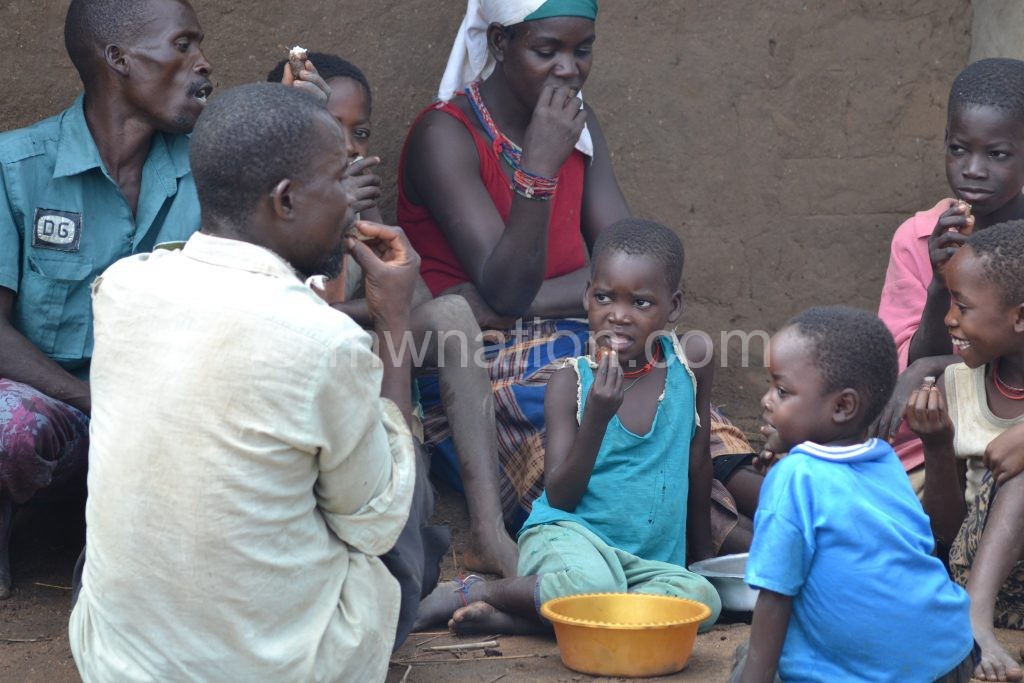 A family shares a meal: Many Malawians face hunger this year