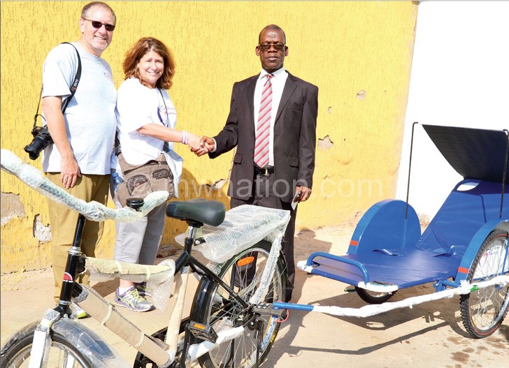 NPL Deputy Chief Executive Officer Alfred Ntonga receives one of the two bicycle ambulances from the Stillman’s