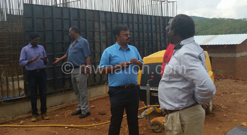 Mtawali with contractors at the construction site