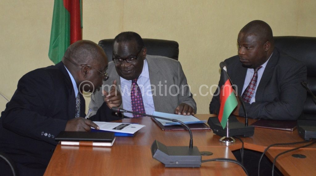 Gondwe (C), Nankhumwa (L) and another official confer during the meeting on Wednesday 