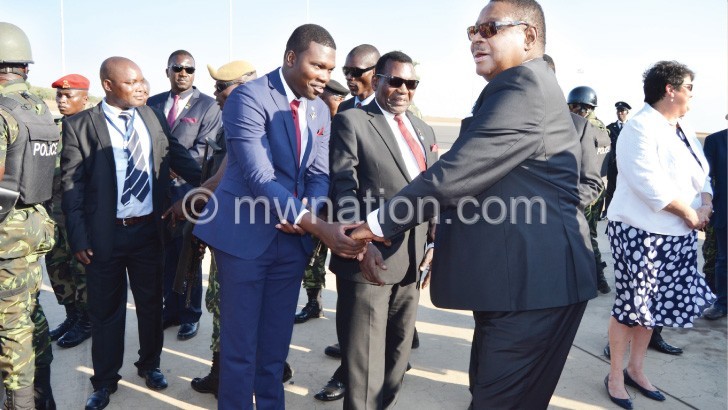 Mutharika greets people on arrival from the United States