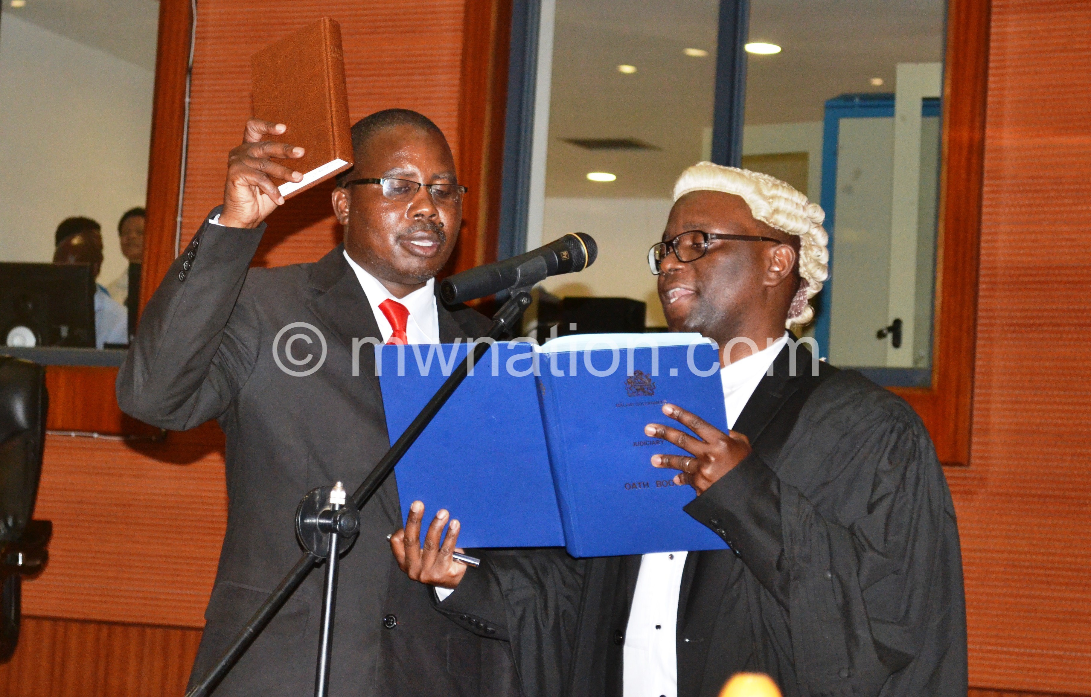 Mwale (L) taking oath of office