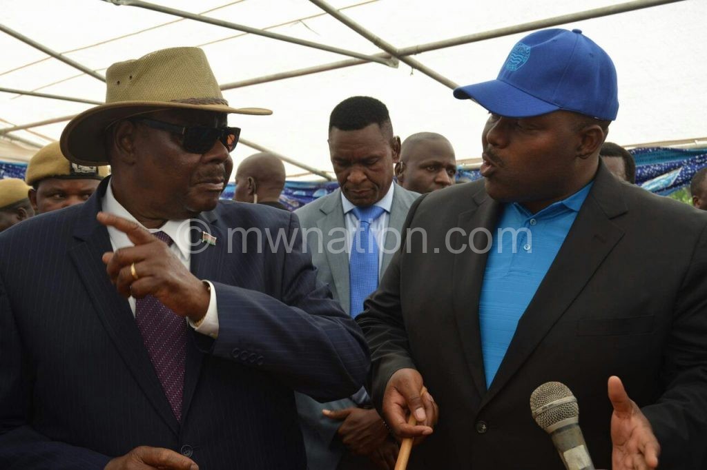 Mutharika (L) being taken around the project site Monday