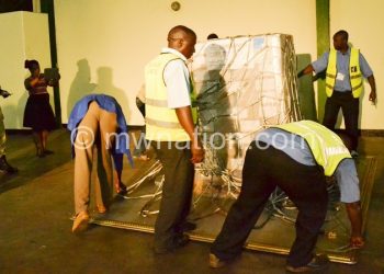 Officials loading ballot papers in a standby warehouse at KIA