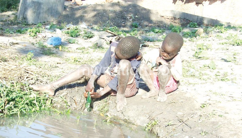 Children playing with water in one of the trenches