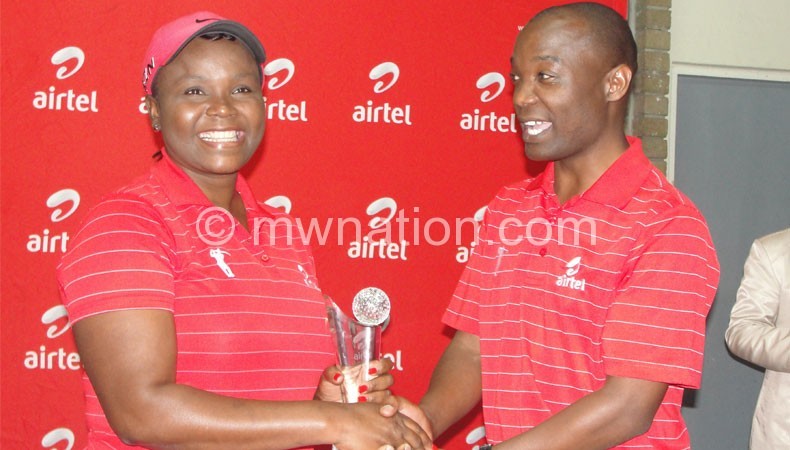 Mbilizi (L) receives her prize from Kamoto of Airtel