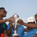 Silver captain Lucky Malata (R) receives a trophy from Asamoah Gyan