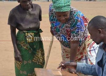 An elderly woman votes during the May elections