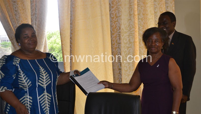 Kalilani (L) receiving the petition from Kamwendo