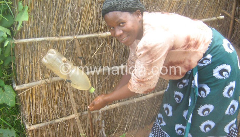A lady demonstrates how it is done after using the toilet