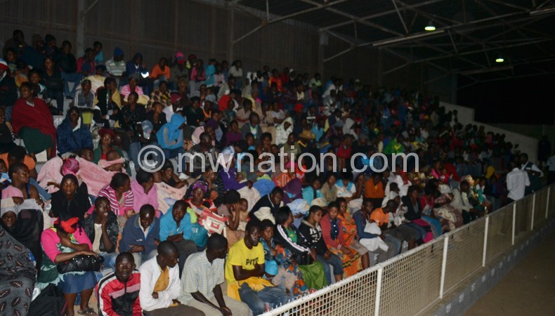 Some of the victims sit on covered stand soon after arrival at Kamuzu Stadium