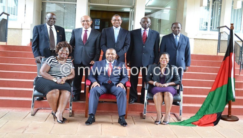 The public service team lead by Chilima (seated C)