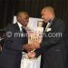 IDI (L) being congratulated by president peter muntharika on his MBC award