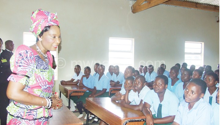 The First Lady interacting with pupils at Baula CDSS where she handed over two school blocks and a teacher’s house