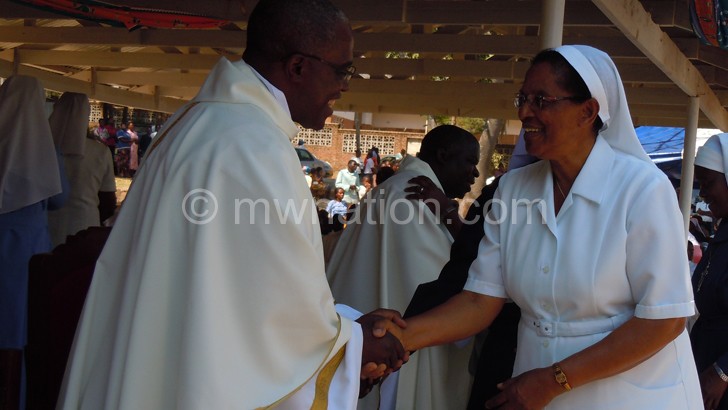 Sister Mary-Claire Chodile (R) congratulates Fr Kuziona on his Silver Jubilee