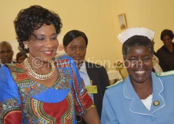 The First Lady (L) shares a light moment with a nurse