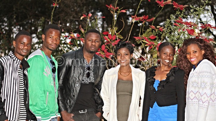 Piksy (3rd from left) posing with brothers and sisters