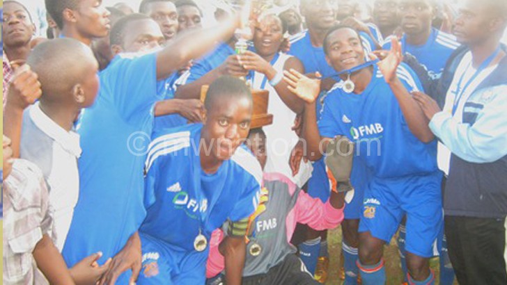 Dedza Police Youth players celebrate with their trophy