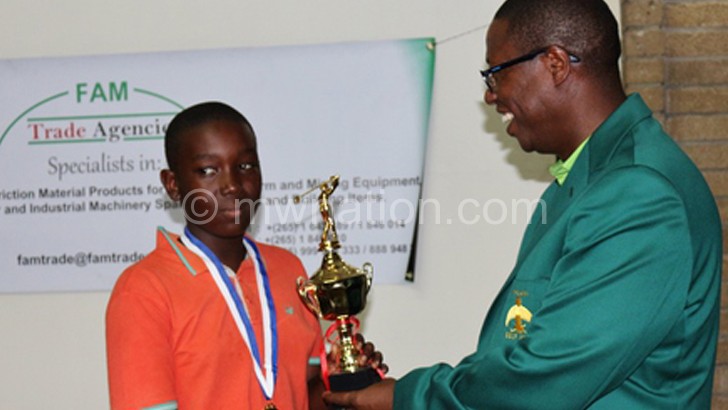 Hill View’s captain Phiri (L) receives his prize from Khomani