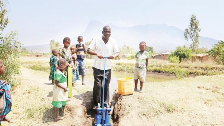 Bisani uses a treadlepump to irrigate his garden