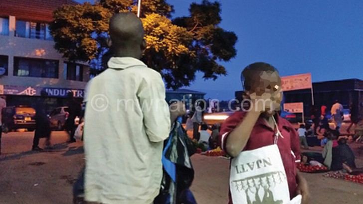 Chifuniro (R) and another child selling plastic bags in Mzuzu City
