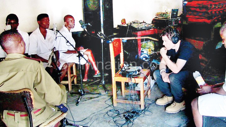 Brennan (C) with the band during a recording session at Zomba Central Prison