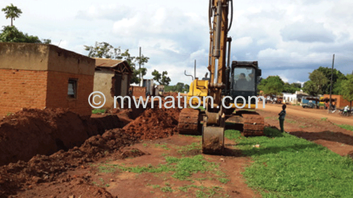 A grader on a section of the Lilongwe-Kasiya-Santhe-Kasungu Road where compensation issues have sparked controversy