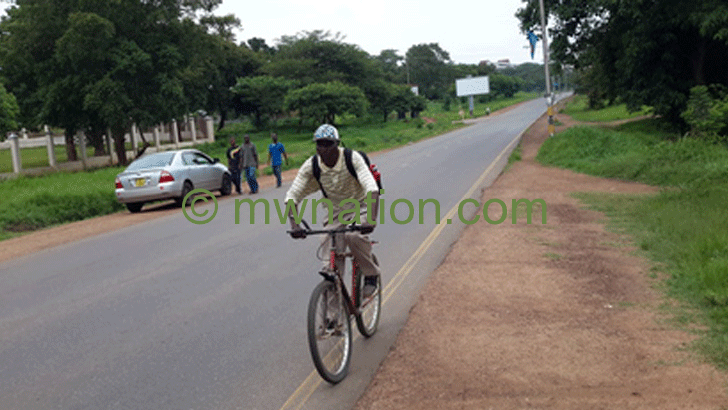 Somanje  on his push bike to present a 
petition to Mutharika